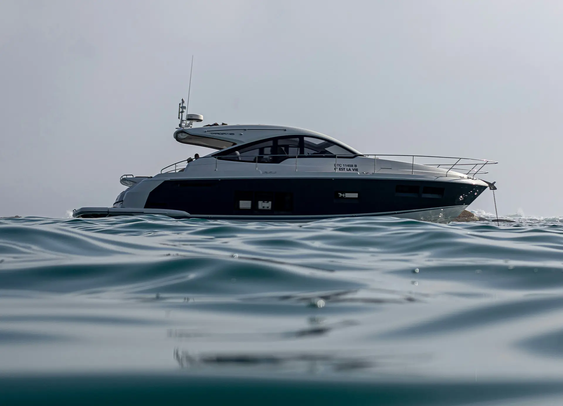 a blue and white boat sitting the water in Miami Beach, FL