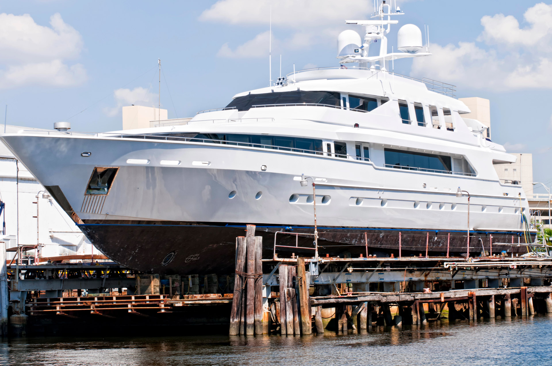Large white yacht in dry dock storage near Pompano Beach, FL